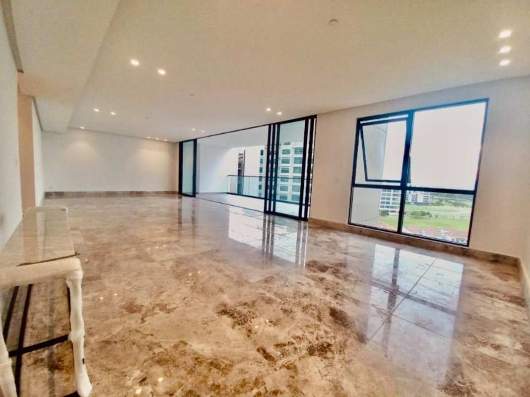 Bright open-plan living space with marble floors and terrace access at Empire Residences Panama City