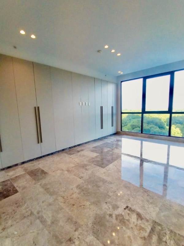 Modern bedroom with marble floors, large window and en-suite bathroom in Empire Residences Santa María Panama