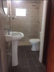 Empty bedroom with tiled floors and window, ready for furnishing in Colón Panama