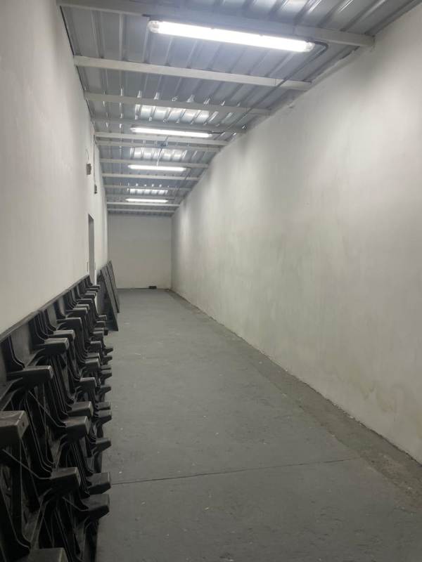 Warehouse space with pallets, cardboard boxes and orange walls in industrial area Panama City