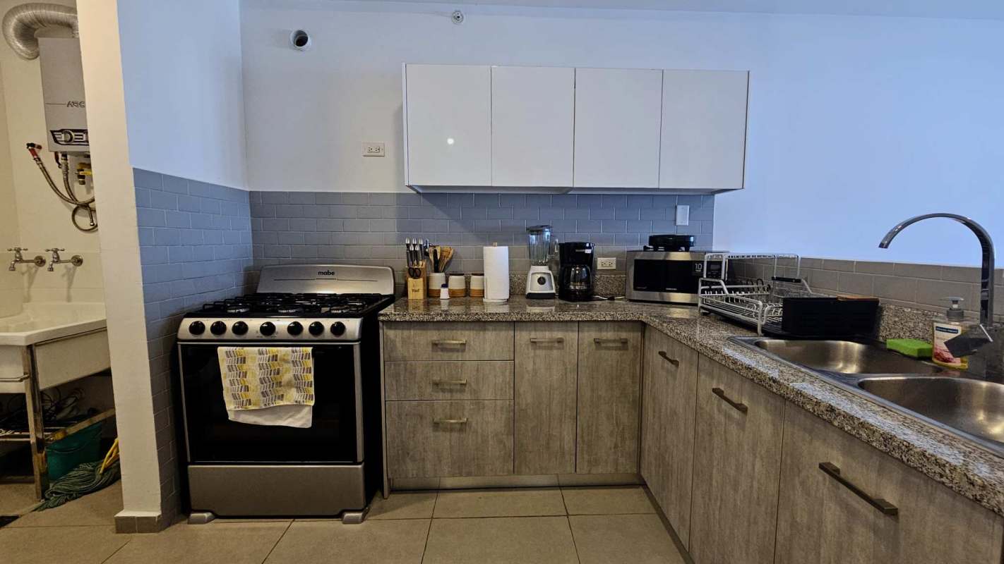Living and dining area with large windows, balcony, in furnished apartment PH La Cresta Panama