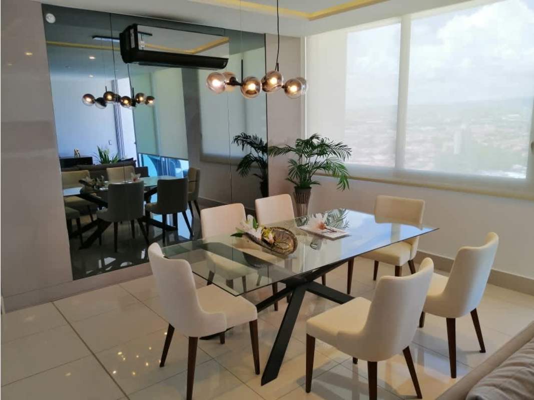 Bedroom with upholstered headboard, built-in closet, and pastel accents in PH Bali Panama