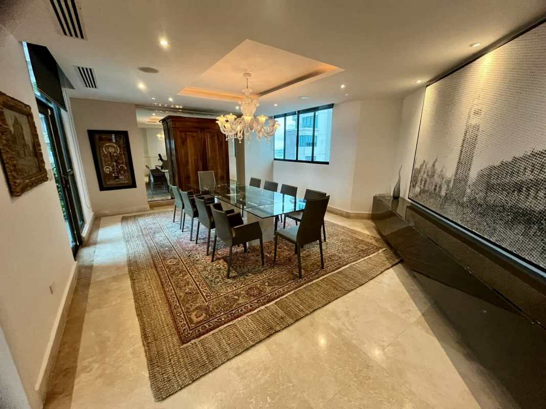 Dining room with marble floor and skyline views in luxury Ocean Park penthouse Panama City