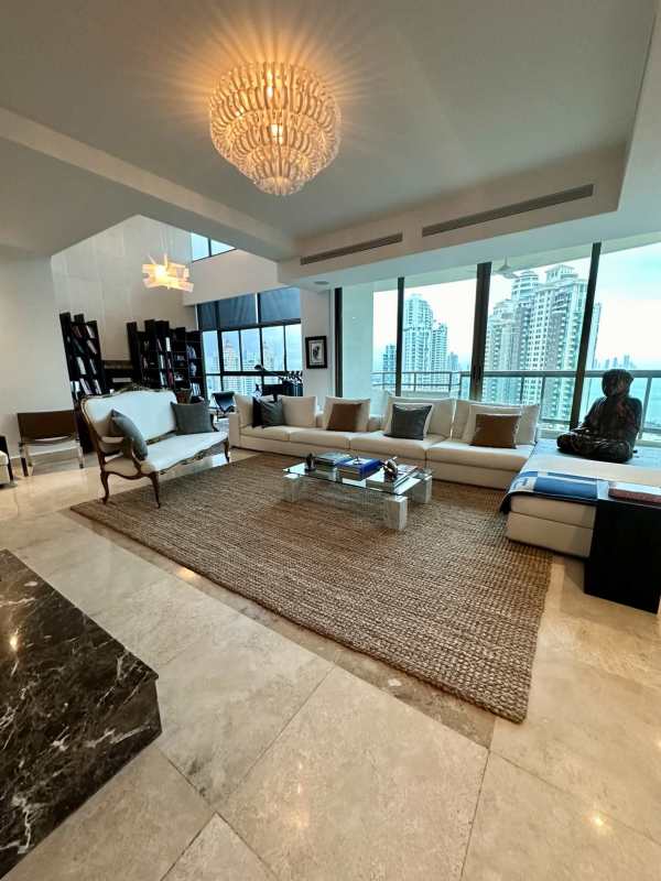 Balcony with glass railing and 180-degree ocean-city views at PH Ocean Park Penthouse Panama