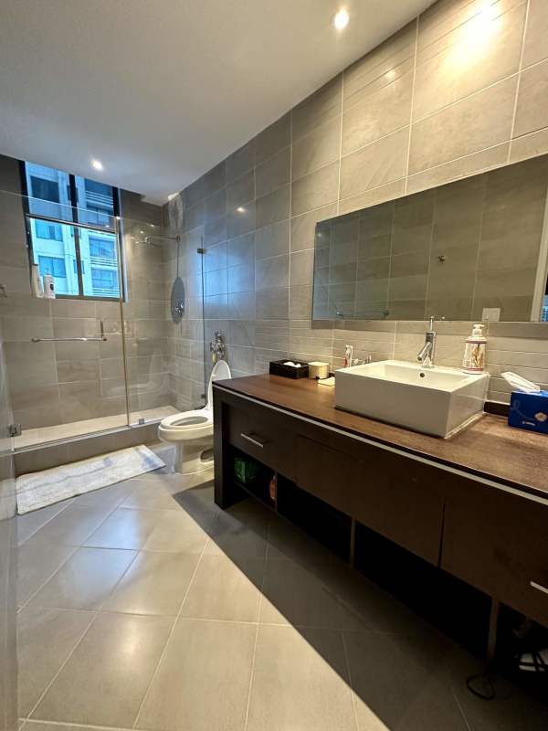 Luxury penthouse bathroom with glass enclosed shower and vessel sinks at Ocean Park Punta Pacifica