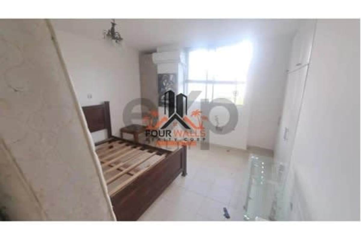 Bright bedroom with large window and skyline view at PH Plaza 77 El Cangrejo Panama City
