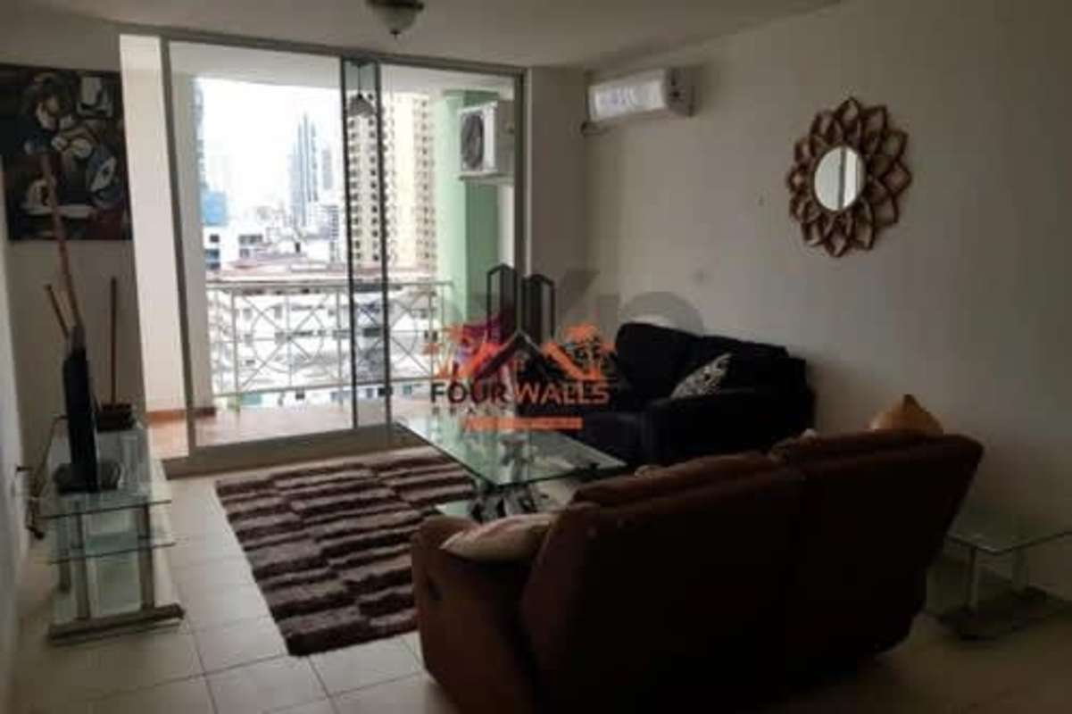 Living room with sliding doors leading to balcony overlooking Panama City PH Plaza 77 El Cangrejo