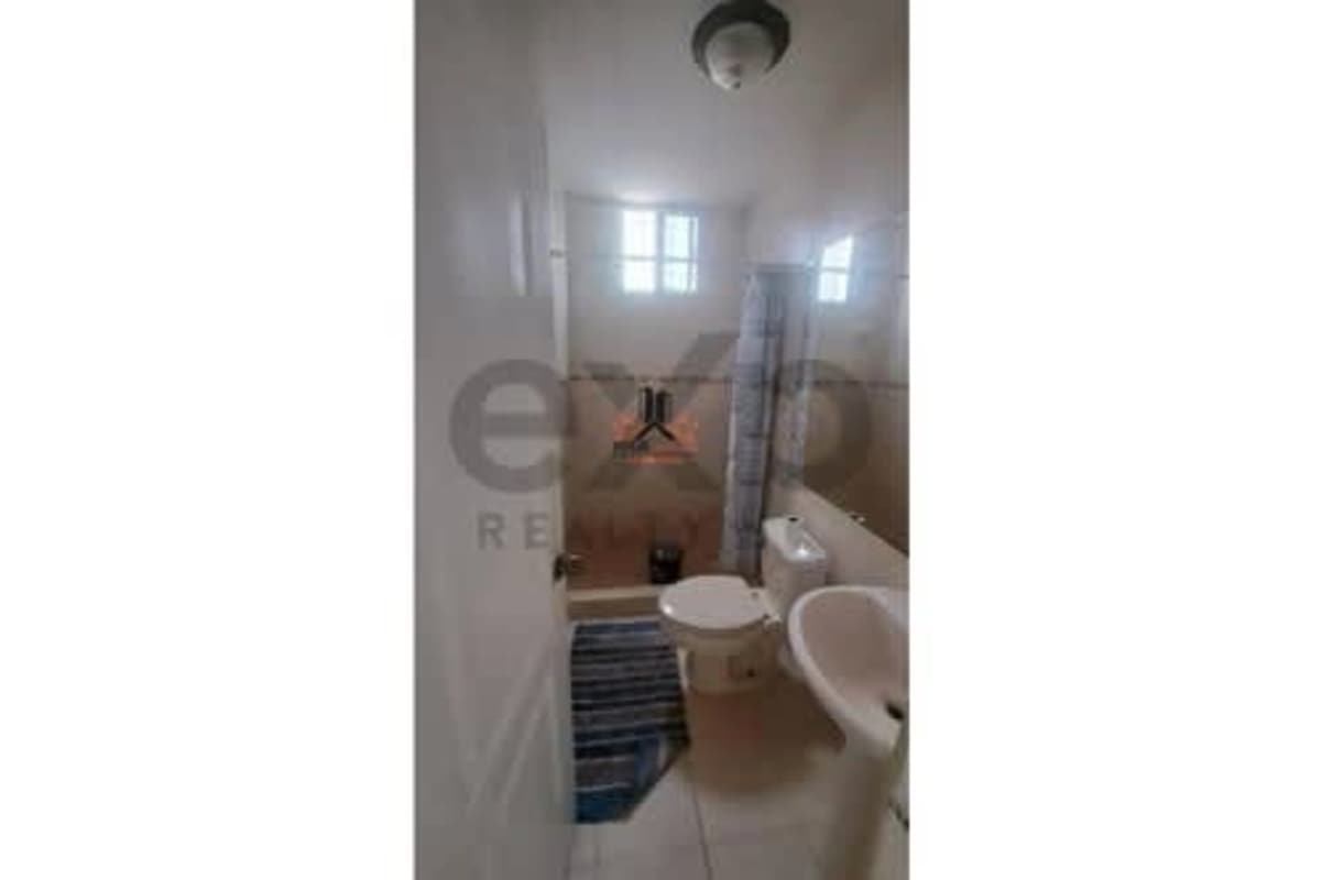 Bathroom with bathtub, shower curtain, white tiles at PH Plaza 77 El Cangrejo Panama City