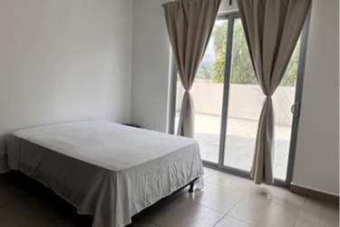 Large bedroom with sliding glass doors to terrace, minimalist decor and natural light in Panama Pacifico