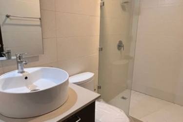 Bathroom with wide vanity, vessel sink, walk-in shower enclosure modern fixtures Panama Pacifico apartment