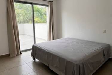Bedroom with sliding glass door to private terrace at PH Mosaic Panama