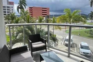 Modern balcony with glass railing outdoor seating and city views in PH Mosaic Panama