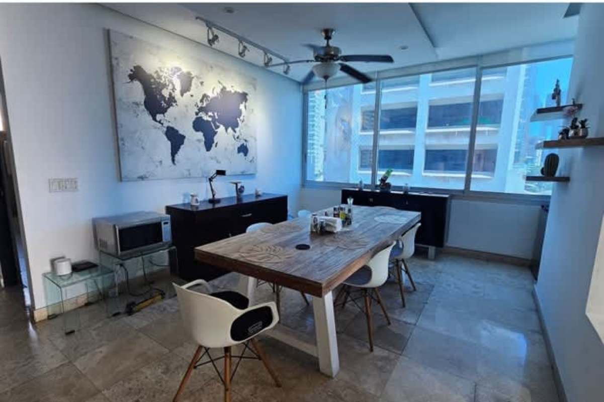 Contemporary conference or dining space with panoramic skyline window and modern design at PH Sky Residences