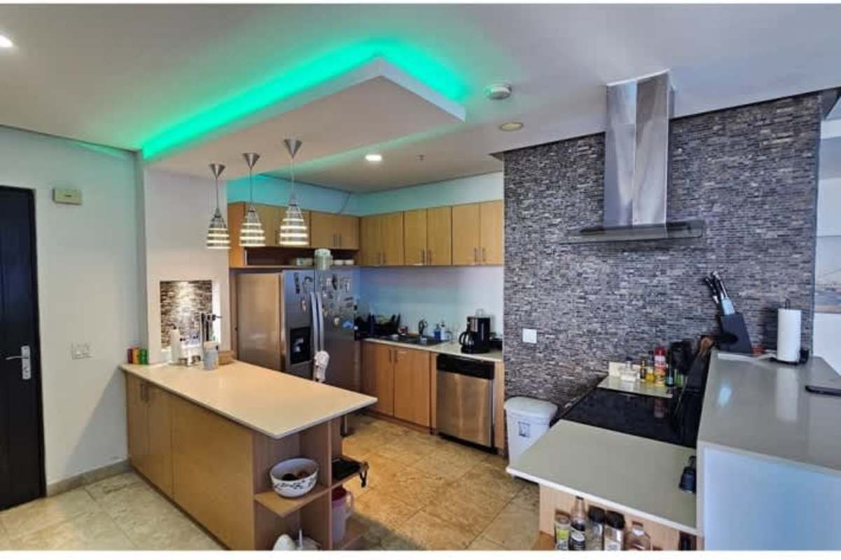 Contemporary kitchen with island, stainless steel refrigerator, built-in oven in PH Sky Residences Avenida Balboa Panama