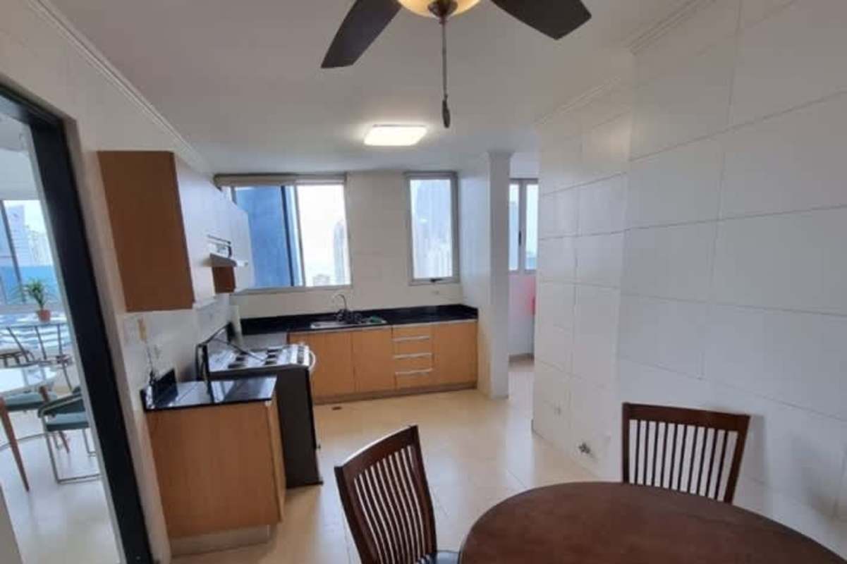 Modern kitchen with granite countertops, wood cabinetry, stainless appliances in Pacific Point Tower Punta Pacifica