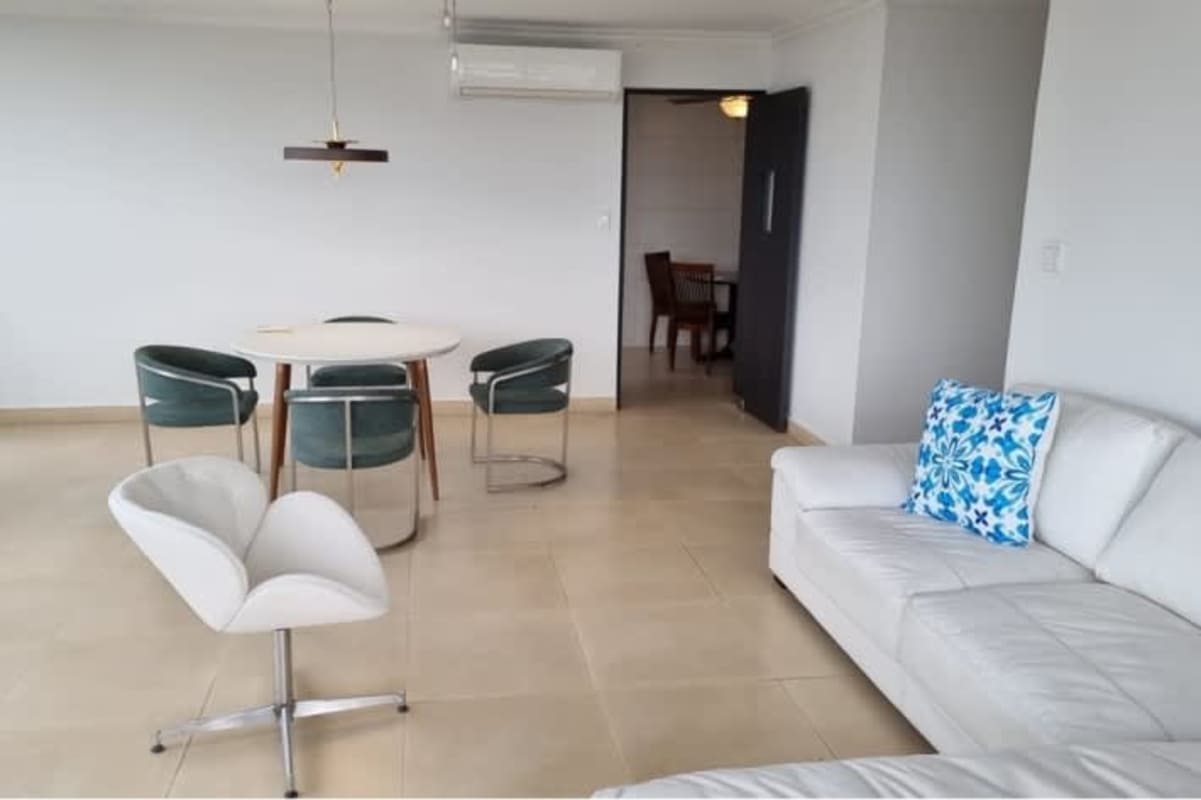 Spacious living dining area with large balcony windows and ocean city views in Pacific Point Tower Panama