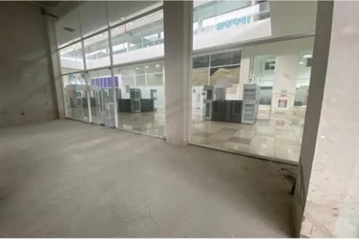 Spacious unfinished commercial interior with glass walls inside Crystal Plaza Mall Panama City