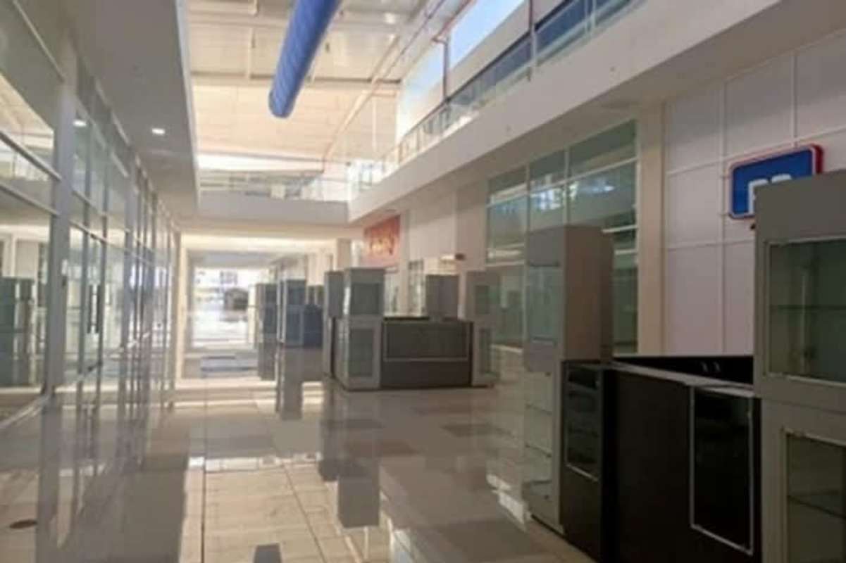 Modern commercial shopping corridor with glass storefronts and mezzanine Crystal Plaza Mall Juan Díaz