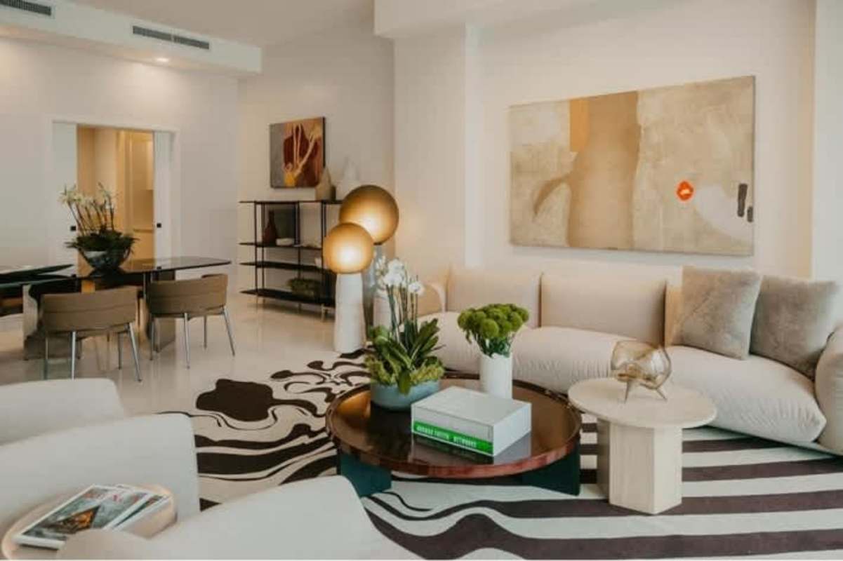 Elegant open living dining with neutral decor, art, stylish furniture in luxury condo