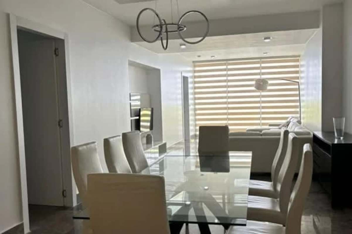 Modern open living dining area with glass table and city views in PH Yoo Panama