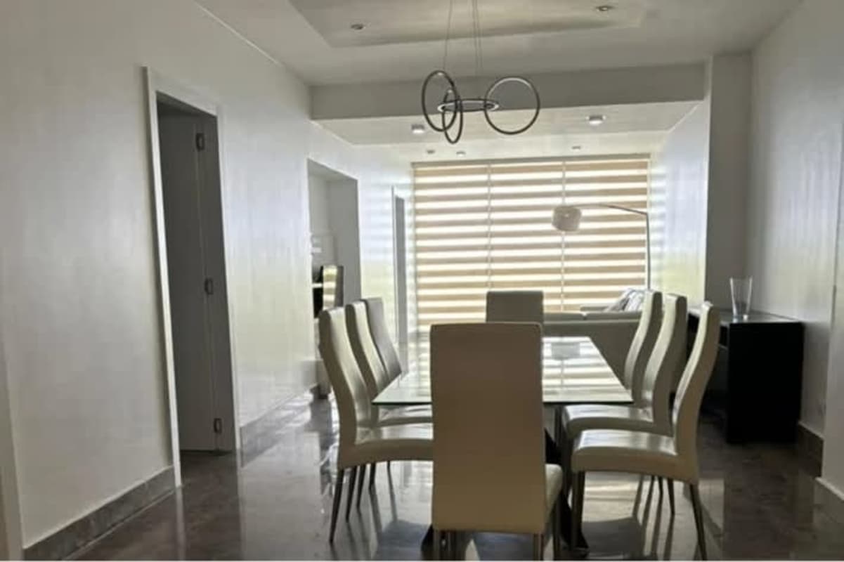 Contemporary dining room with glass table, city views at PH Yoo Panama