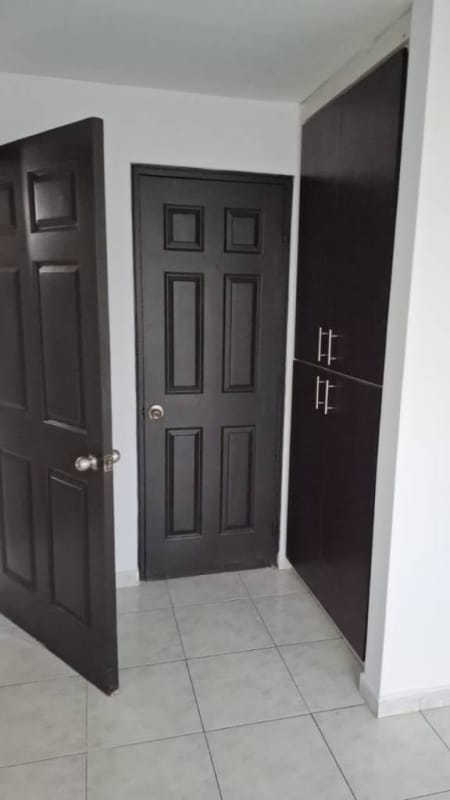 White kitchen with upper and lower cabinets and granite counter in PH Ocean Sky Panama