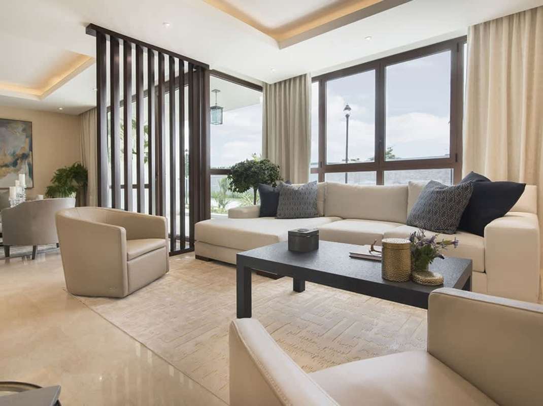 Bright living room with large sectional sofa and open design at The Colonial Residences Santa María Panama