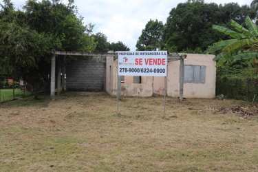 Unfinished house structure with a for sale sign in grassy yard rural Chupampa Santa Maria Herrera Panama