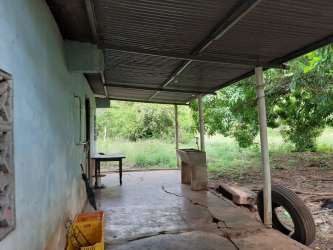 Flat country lot with rustic metal shed and fence just outside Santiago, Veraguas