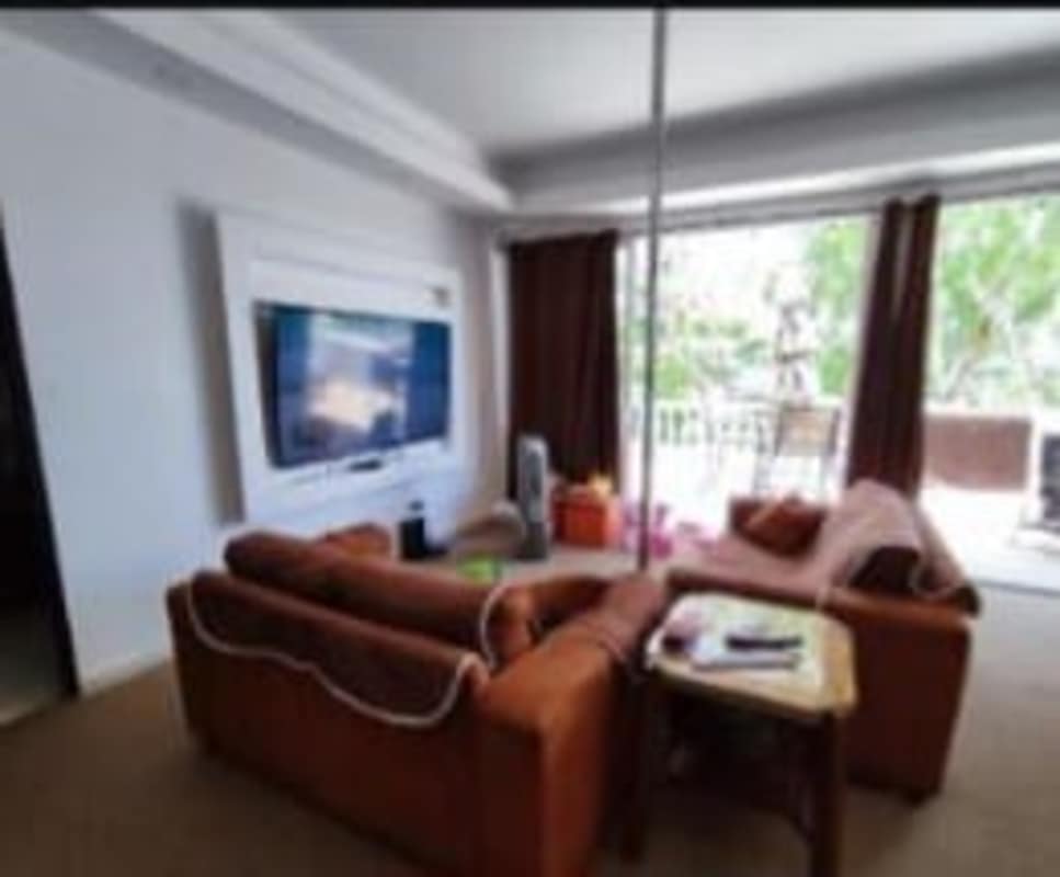 Spacious living room with mounted TV and access to balcony in El Bosque Panama