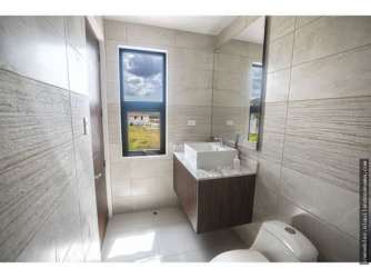 Spacious bathroom with vanity, large window and natural light in house for sale Costa Verde Panama