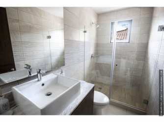 Stylish bathroom with vessel sink, glass shower enclosure at Costa Verde house Panama