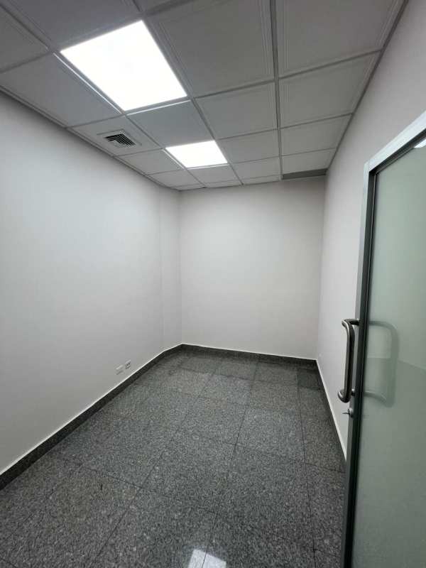 Office corridor with tiled floor, glass doors and gray walls Plaza Fidanque Panama