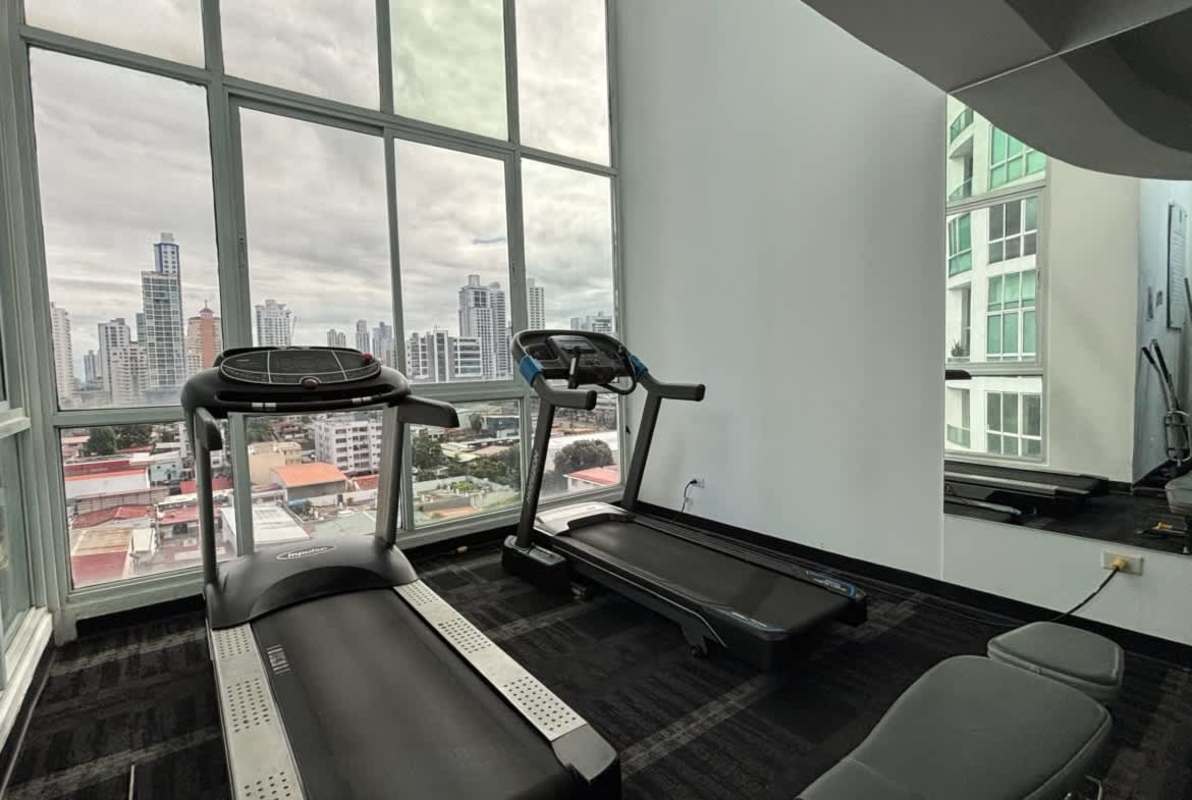 Modern rooftop pool with lounge area, hot tub, overlooking Panama City skyline at The Cosmopolitan San Francisco