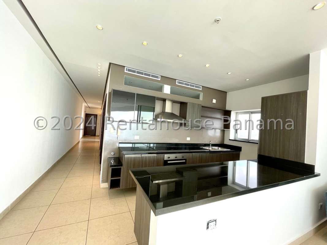 Contemporary kitchen with granite counters and stainless steel appliances in PH Rivage apartment Panama City