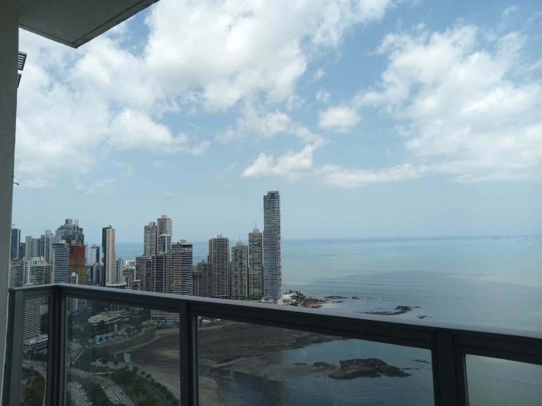 Large balcony with glass railing and panoramic Pacific skyline views in PH Yoo Panama