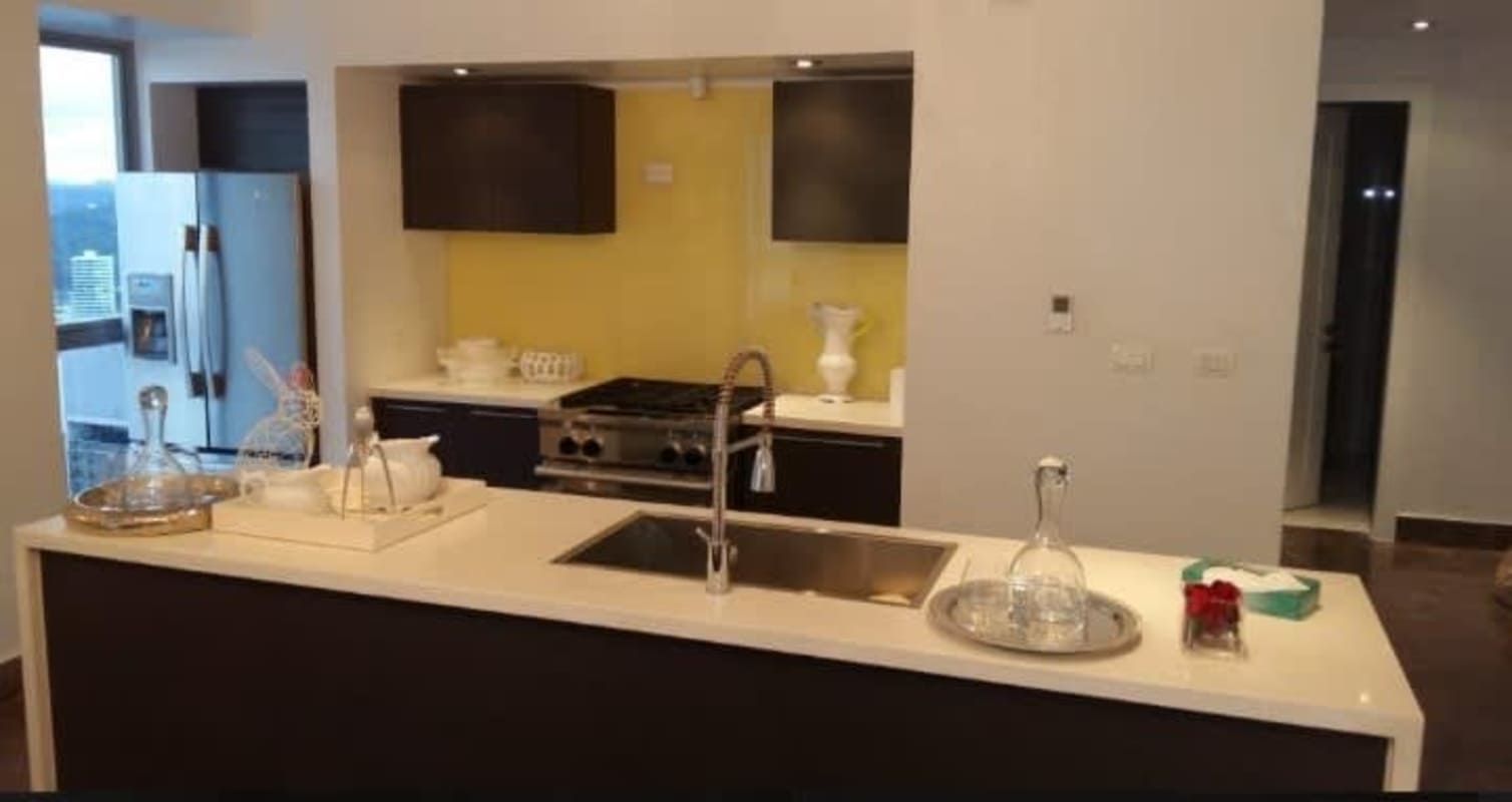 Modern kitchen with stainless appliances island and designer lighting in PH Yoo Panama