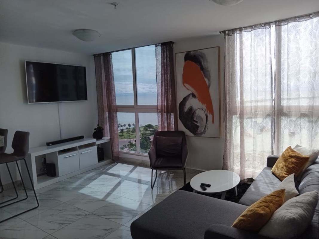 Dining space with ocean and Panama skyline views in modern apartment for rent