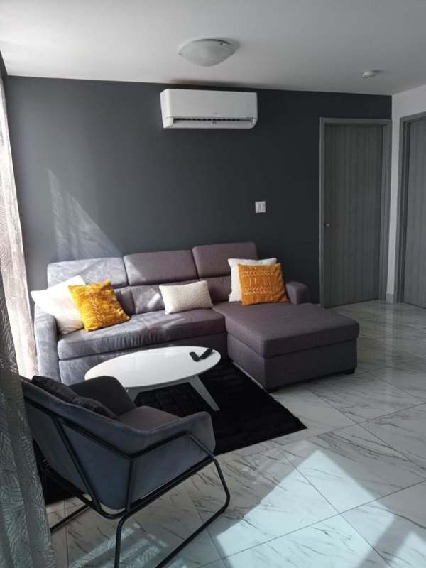 Modern living room leading to balcony with Pacific Ocean views in PH The Sands Panama