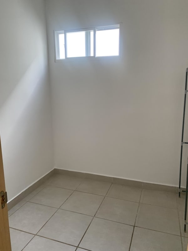 Compact utility room tiled with small window storage options in Brisas del Golf rental house Panama