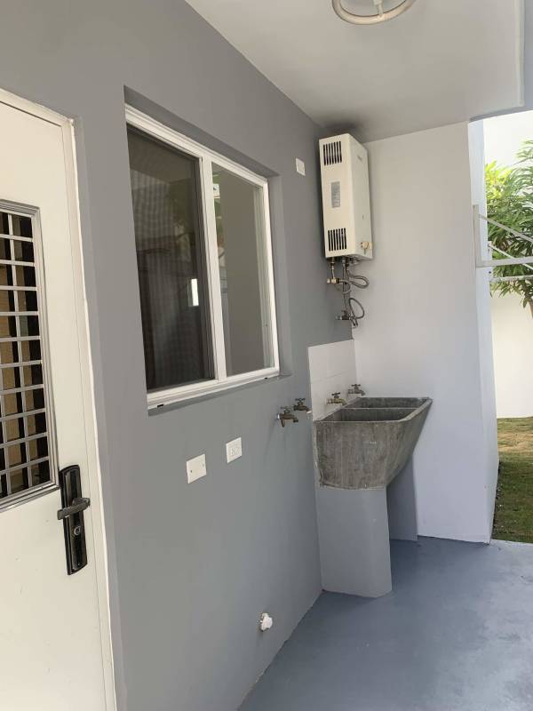 Outdoor laundry area with sink window heater access in Brisas del Golf house for rent Panama