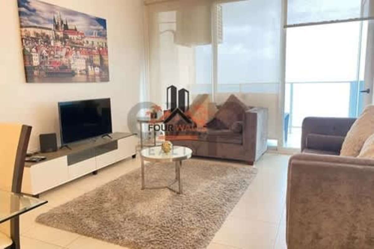 Bright living room with city view, brown sofas, TV console at PH Waters on the Bay Panama