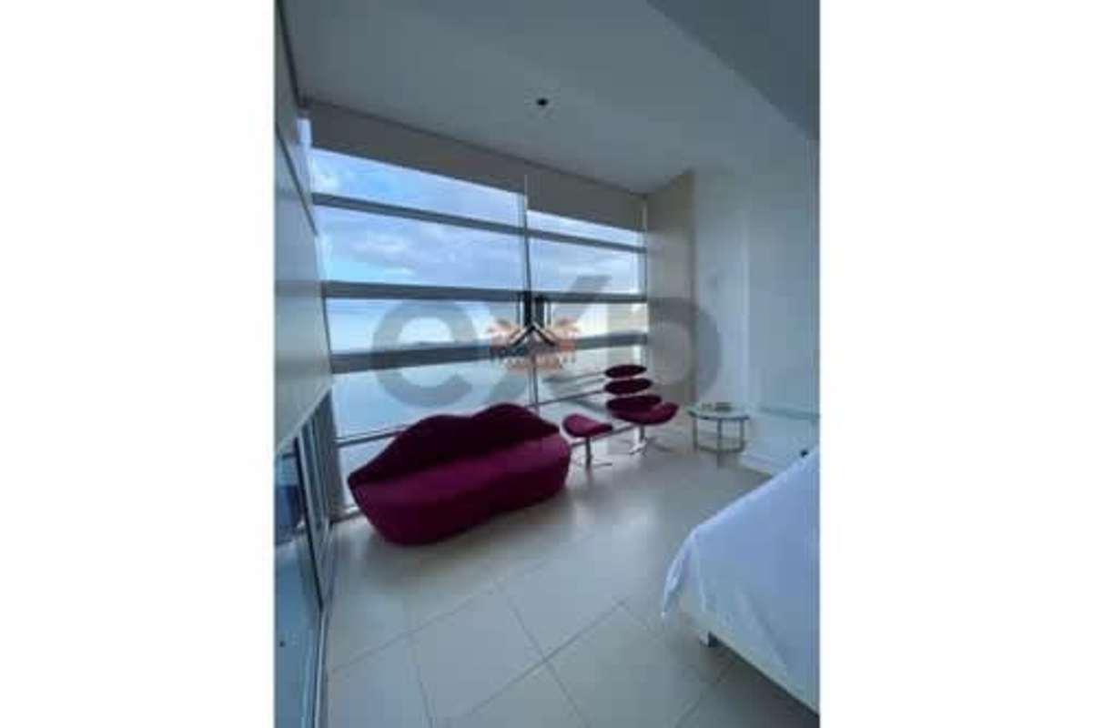 Bright second bedroom with panoramic windows overlooking ocean and city skyline PH Waters on the Bay Panama