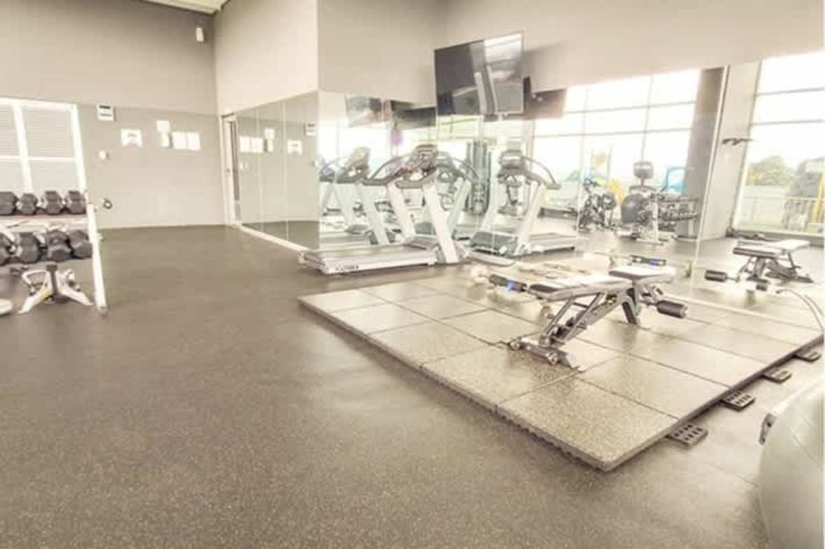 Fitness gym with treadmills, weights and mirrors at PH Green View Panama City