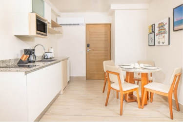 Cozy dining nook with panoramic ocean views at Surfside Playa Caracol