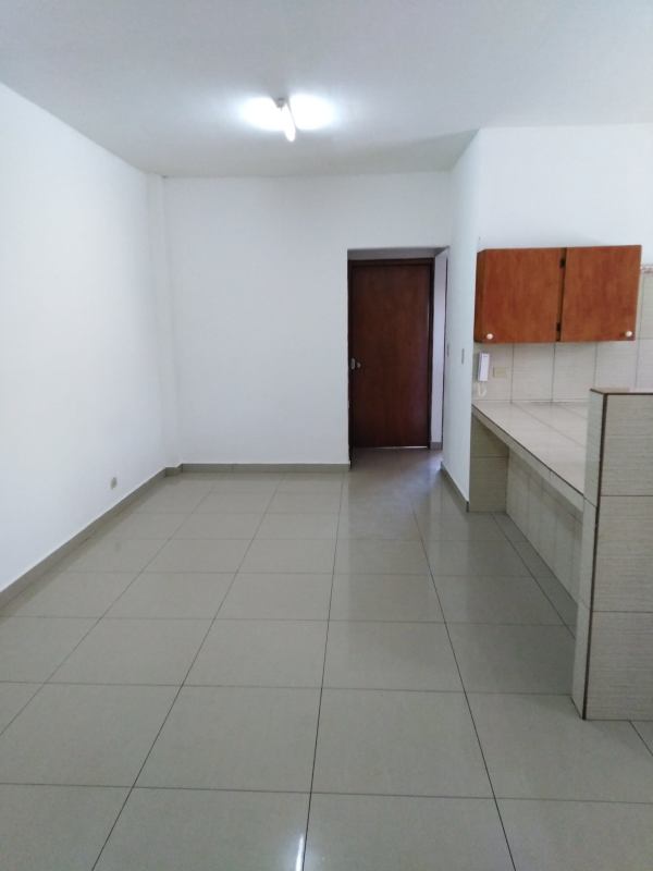 Bright tiled kitchen with wooden cabinets and countertop at Edificio Ramimar Parque Lefevre Panama