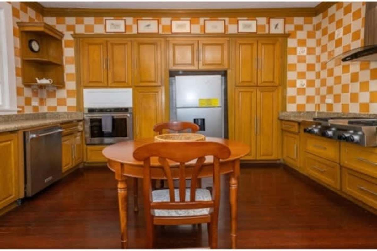 Classic kitchen with wood cabinetry and modern updates in historic Panama house
