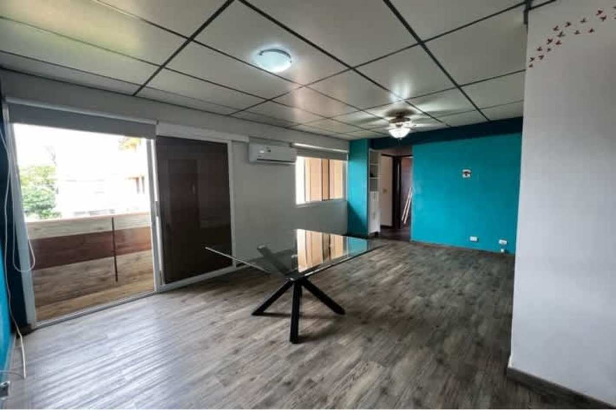 Living and dining room with sliding balcony door and AC in PH Carmen Edith Panama