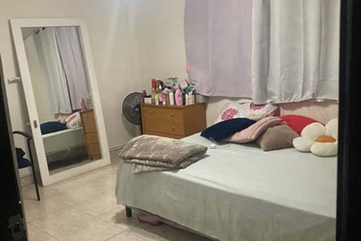 Simple bedroom with tiled floor window and curtains in affordable 3 bedroom apartment in Rio Abajo Panama City