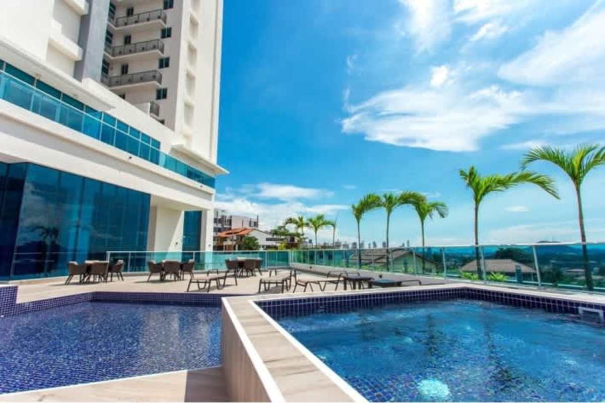 Modern pool and jacuzzi terrace overlooking city skyline at PH Dos Mares Betania Panama